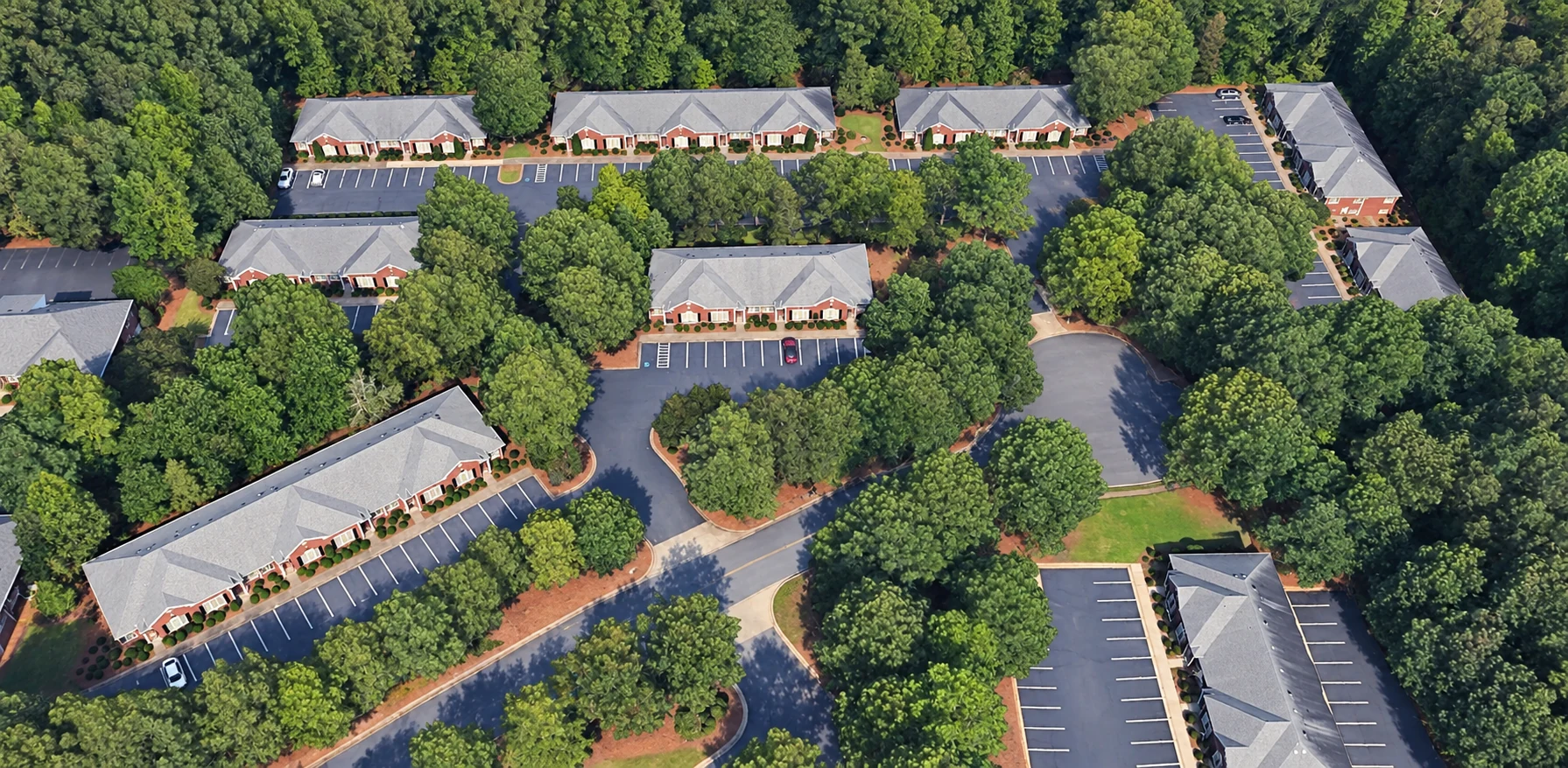 Aerial view of the office buildings, parking areas, and tree-lined grounds at 500 Sun Valley West in Roswell, Georgia.